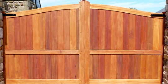 Framed solid arched top driveway gate